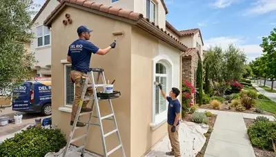 Professional house painters working on residential exterior in Modesto, CA